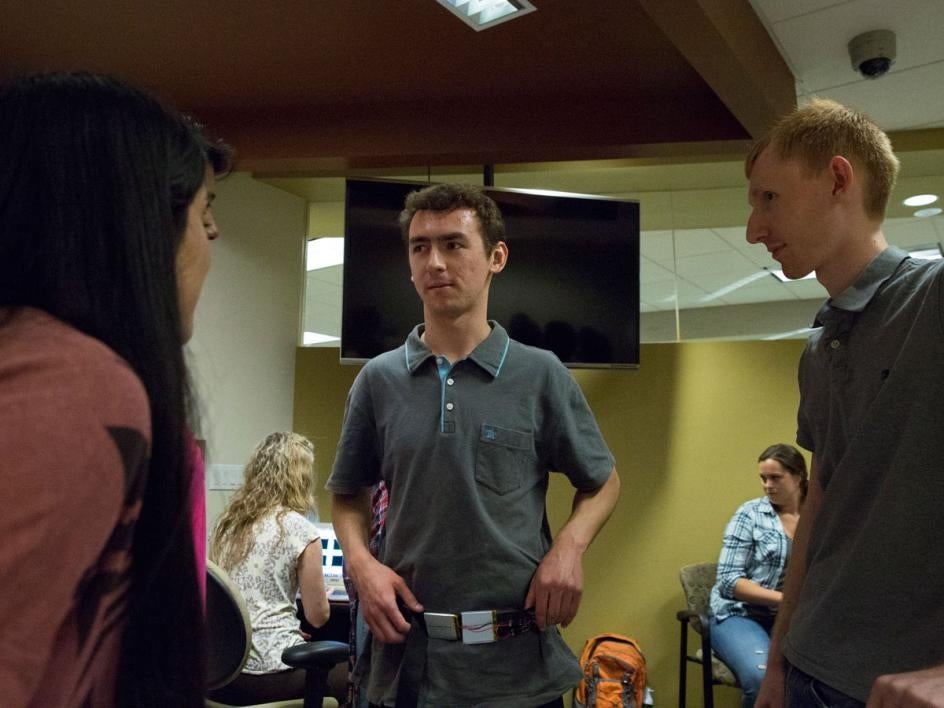 Civil, environmental and sustainable engineering graduate student Jordan Rodriguez (center) tries on the Haptic Compass Belt at the CSE 591: Assistive Technologies Demo session on April 26, 2016.