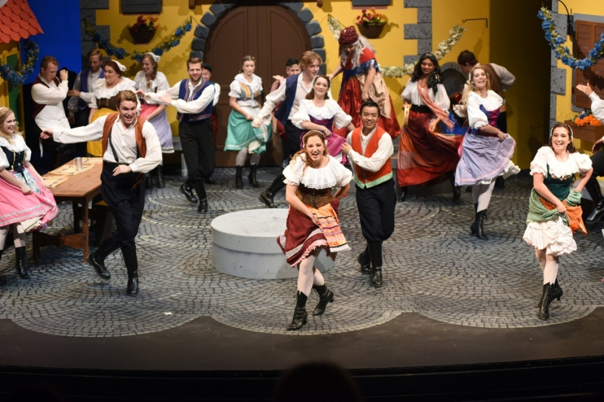 A group of performers in costume during a show.