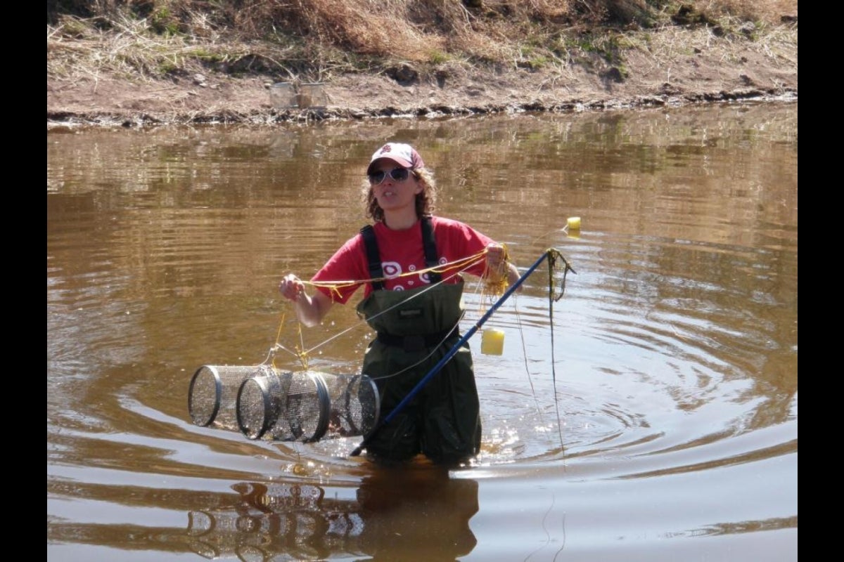 woman with fishing net in lake