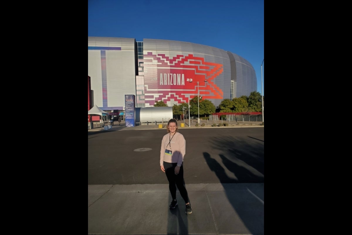 ASU student Bekah James posing outside State Farm Stadium in Glendale, Arizona, before Super Bowl 57.