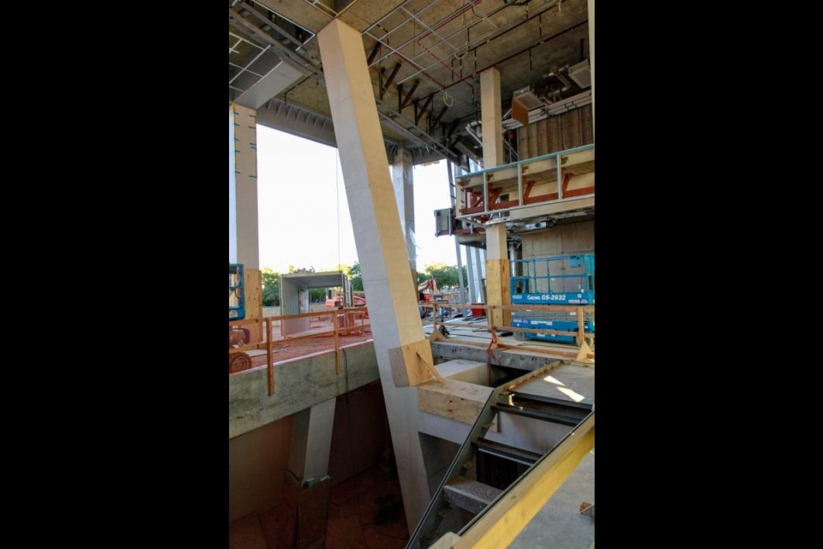 The ground floor lobby connects to the basement via an architectural staircase