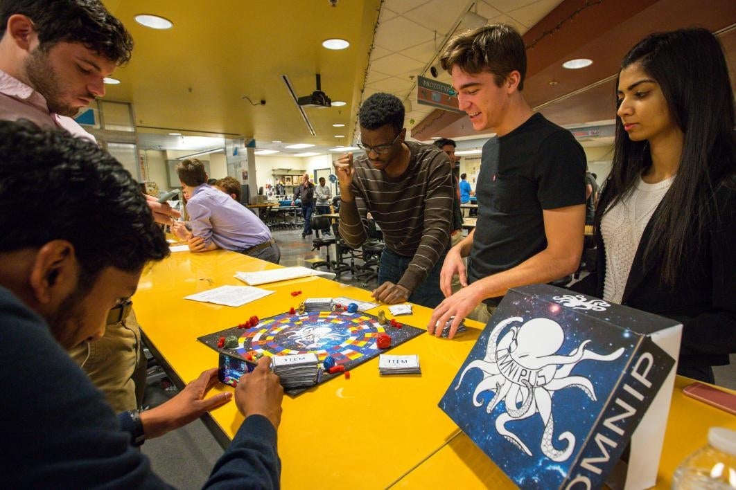 Students play a board game.