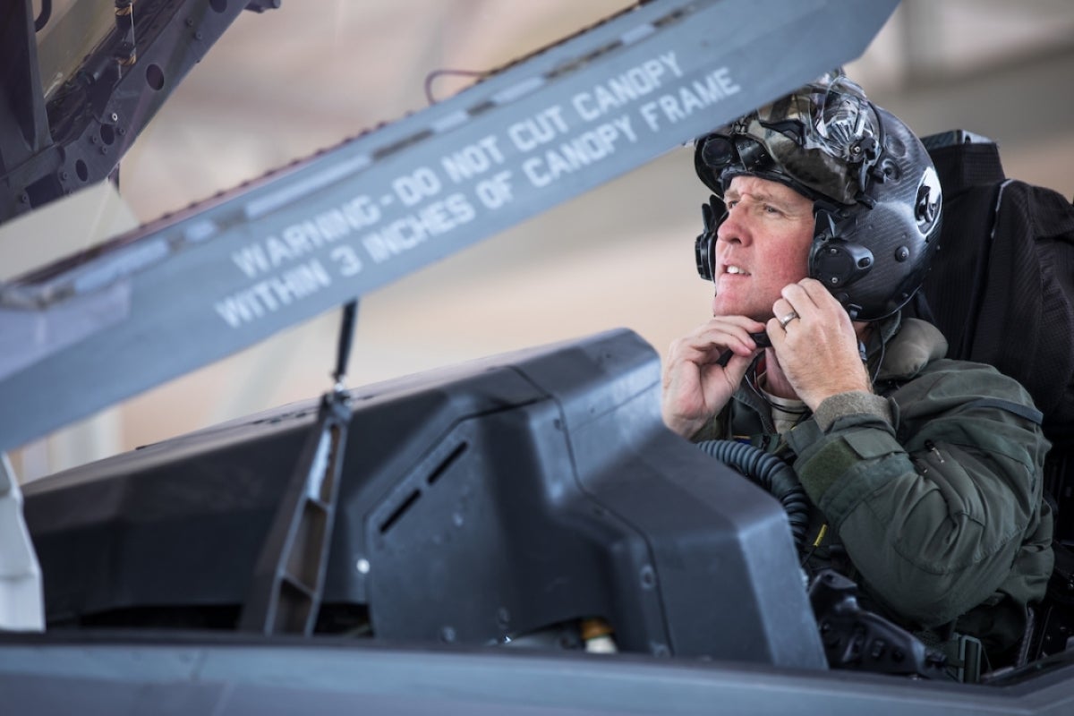 Pilot straps on his helmet