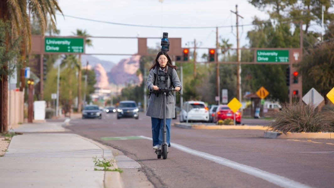 ASU graduate student Chialing Wei rides an electric scooter while collecting lidar data.