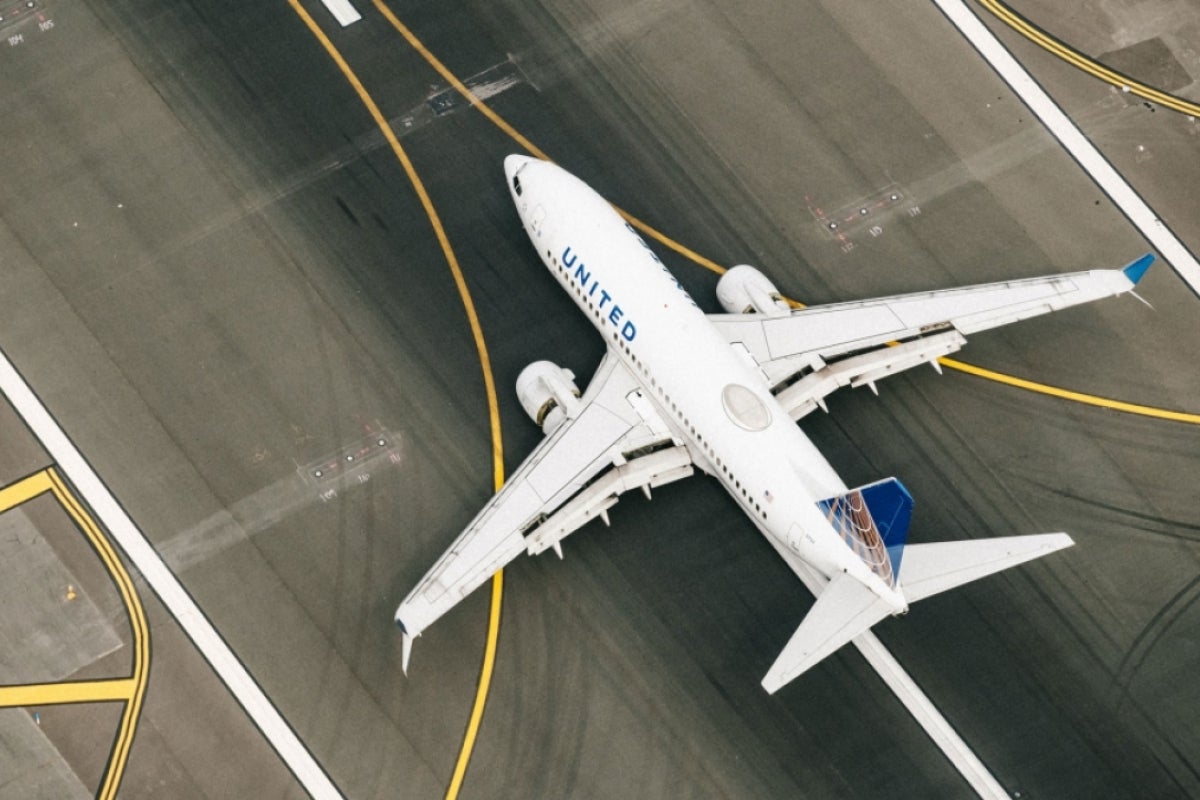 An airplane on the tarmac as seen from above.