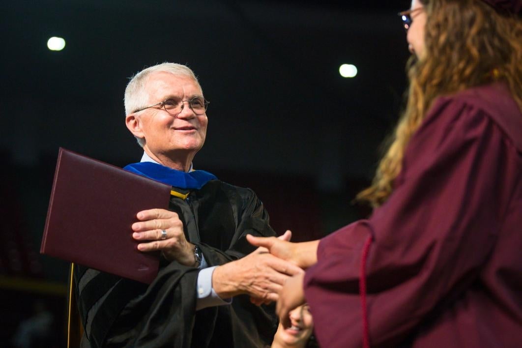 dean shaking graduate's hand