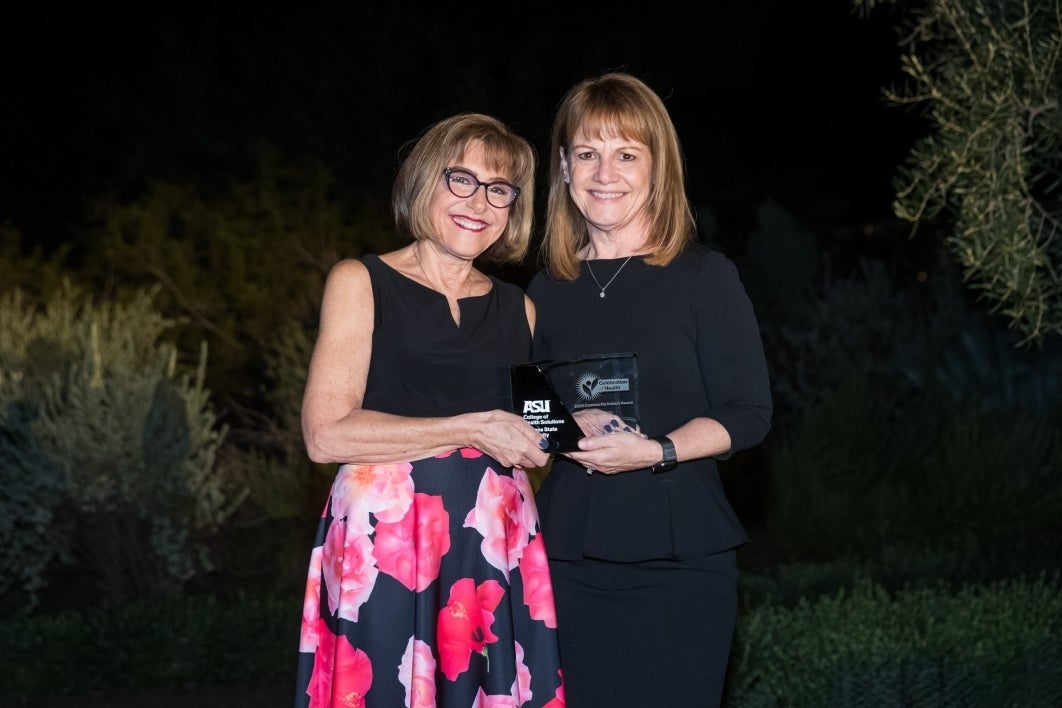 College of Health Solutions Dean Deborah Helitzer (left) poses with Kim Despres of Circle the City.