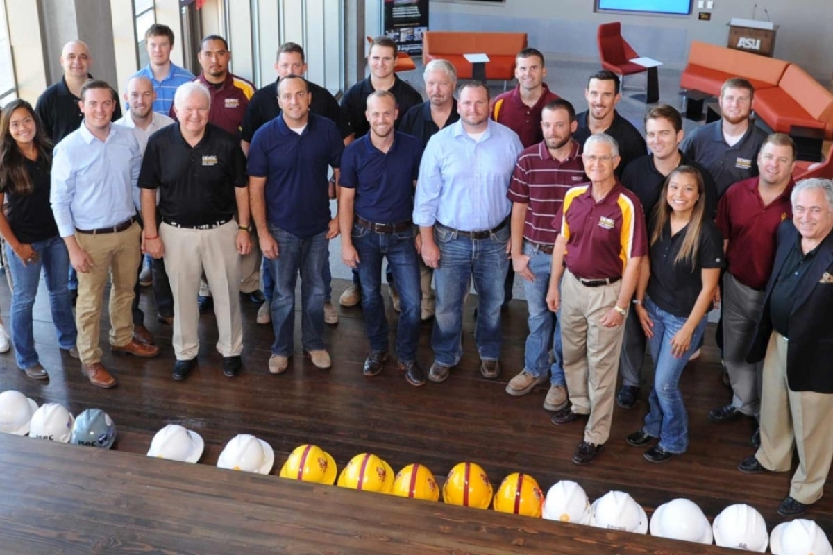 Edd Gibson, pictured with a group of Del E. Webb School of Construction alumni who worked on the College Avenue Commons building project.