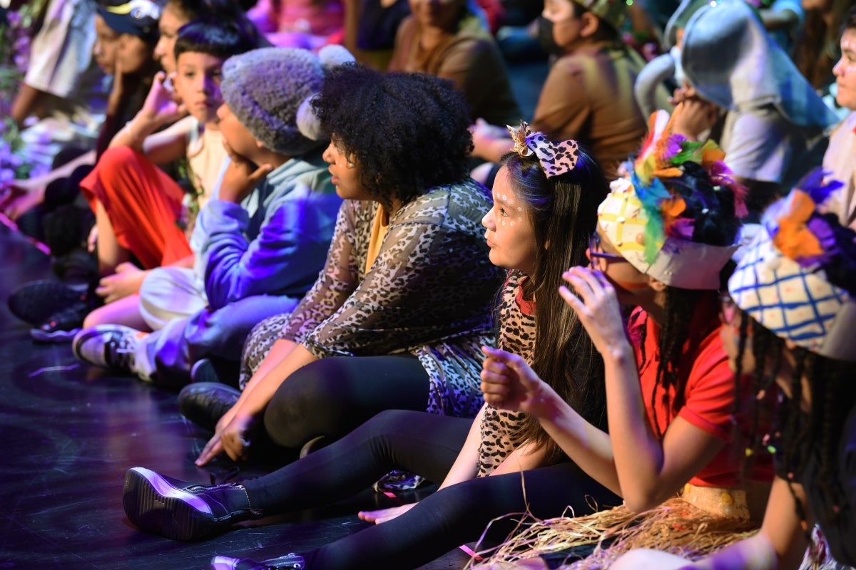 Group of children sitting on the floor.