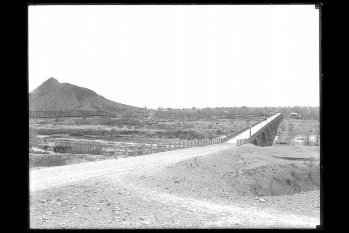 Desert cityscape with a bridge.