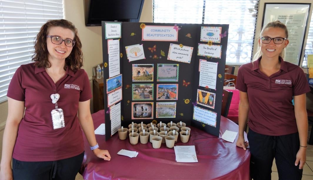 ASU nursing students pose with the poster they created for a health fair