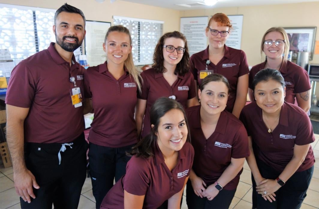 ASU nursing students pose for a photo after finishing up at a health fair they created and hosted at Crossroads Flower