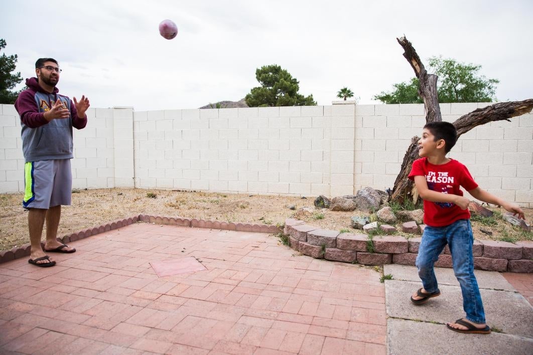 man throwing football with boy