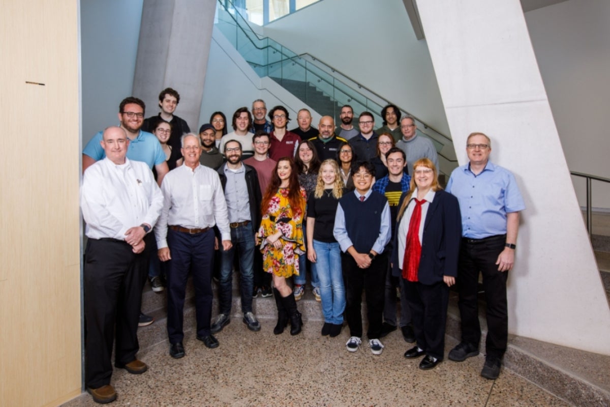 Group photo of the CXFEL team members in the lobby of an ASU building.