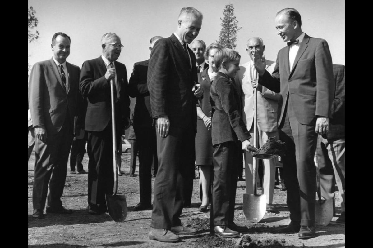 men holding shovels at building groundbreaking