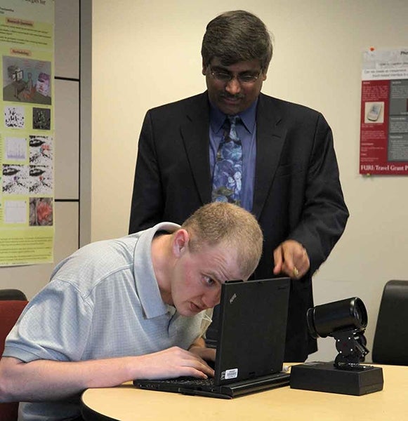 David Hayden (seated) works with Sethuraman 