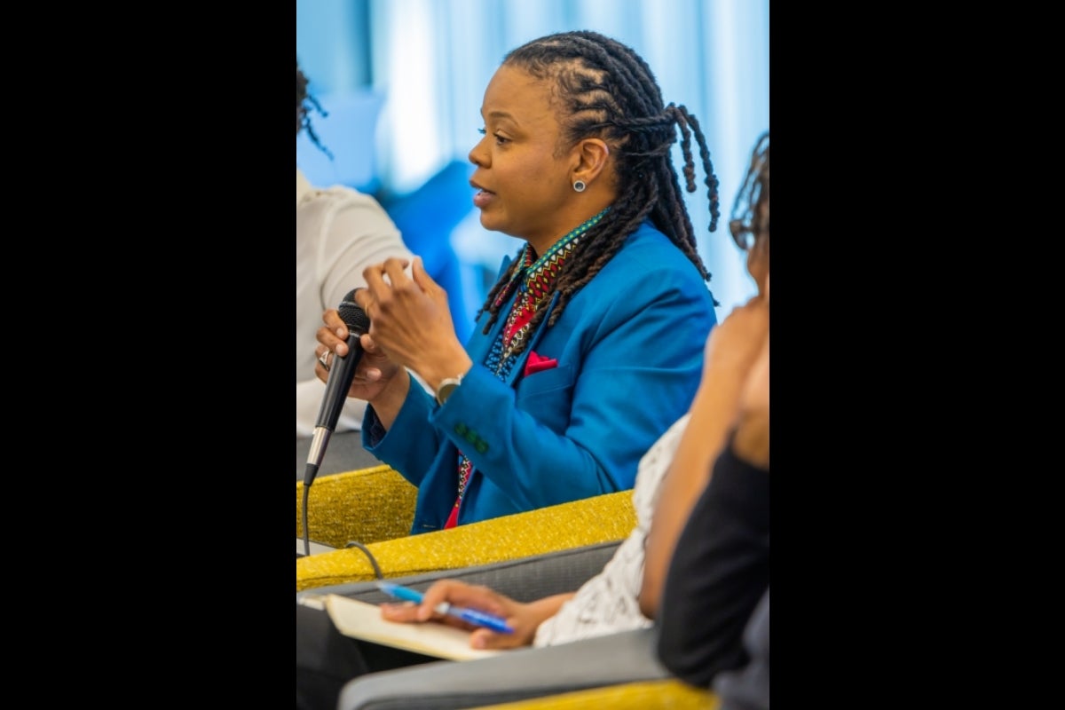 Professor Coley shown speaking into a mic.