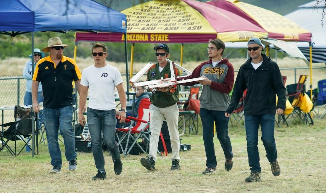 Don Wood, Nick Kolesov, Evan Draganchuk, Dan Kosednar and Luke Burgett take the ASU team’s aircraft to the flight line at the AIAA DBF competition in Tucson, Arizona.