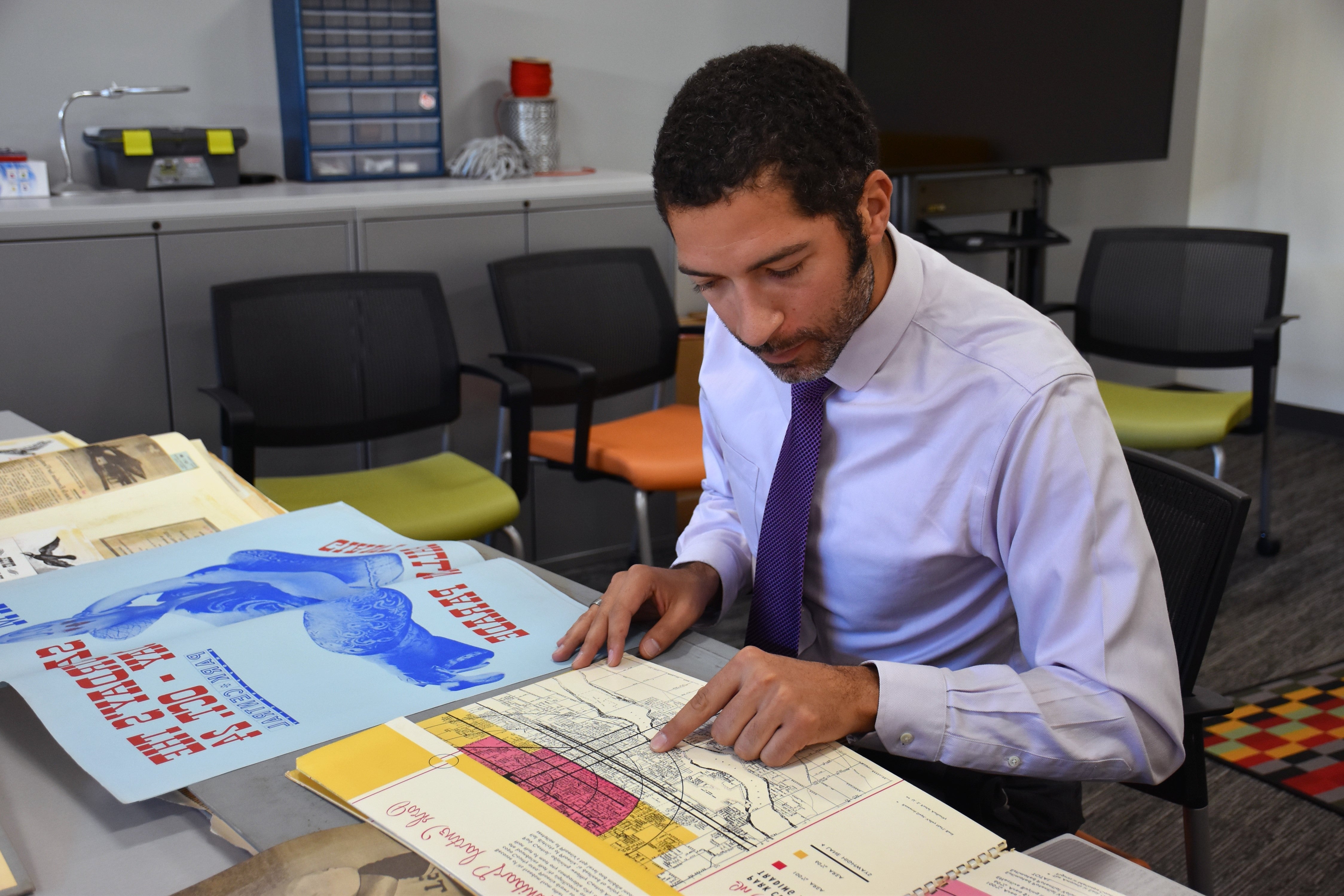 Matt Delmont looks through Park Central Mall historic documents