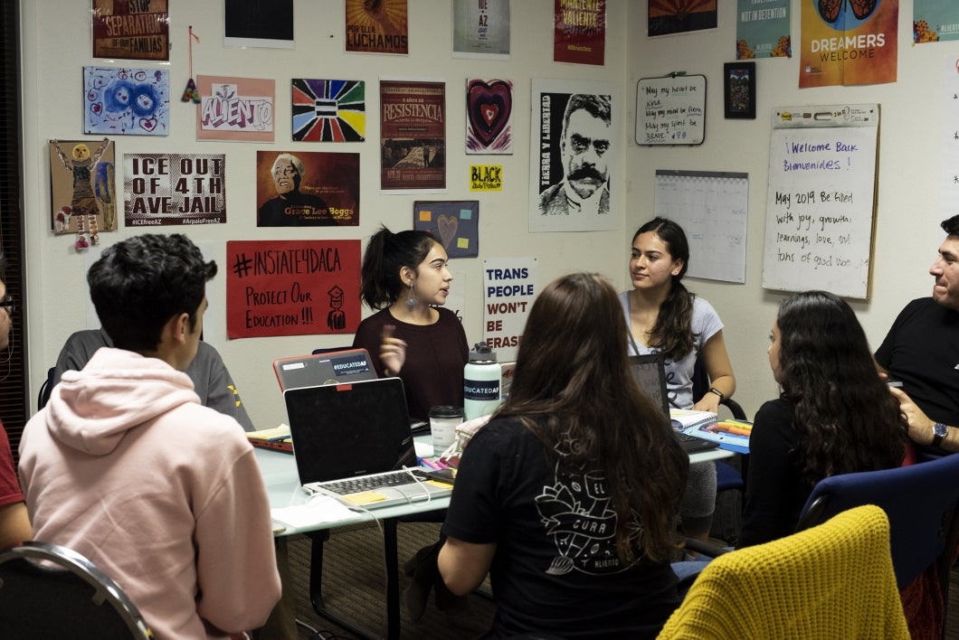 Student leaders from Aliento's youth fellowship program in a meeting at the group's Mesa office.