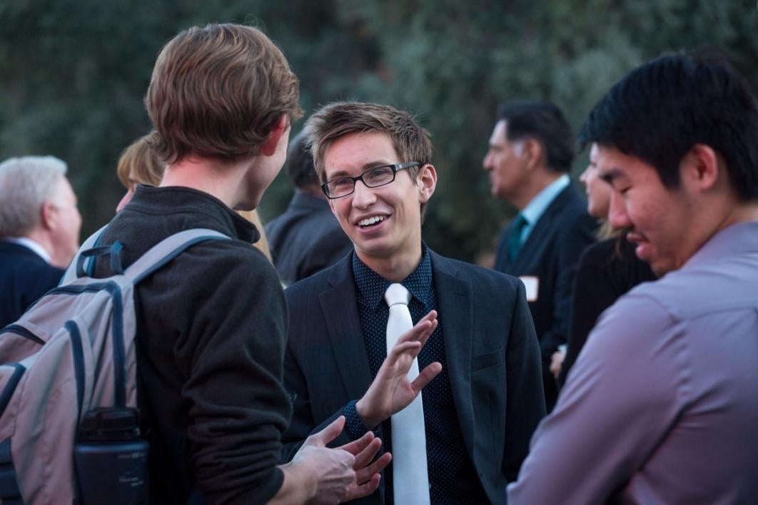 People in a crowd talk.