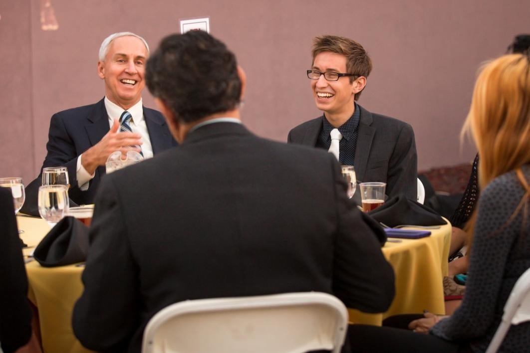 People laughing it up at a dinner event.