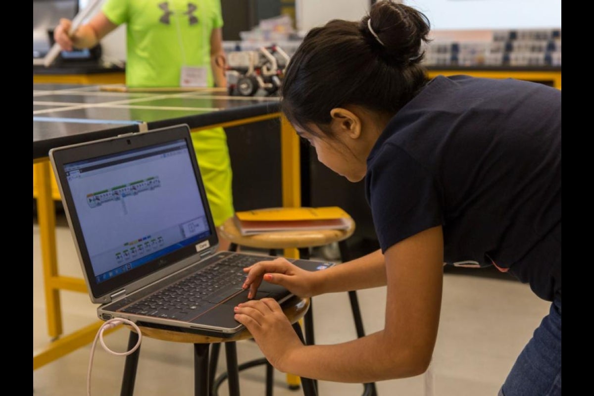 A student adjusts the robot's programming in the LEGO MINDSTORMS EV3 software