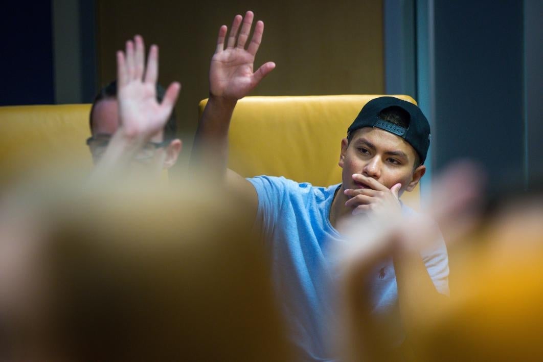 student raising hand in class