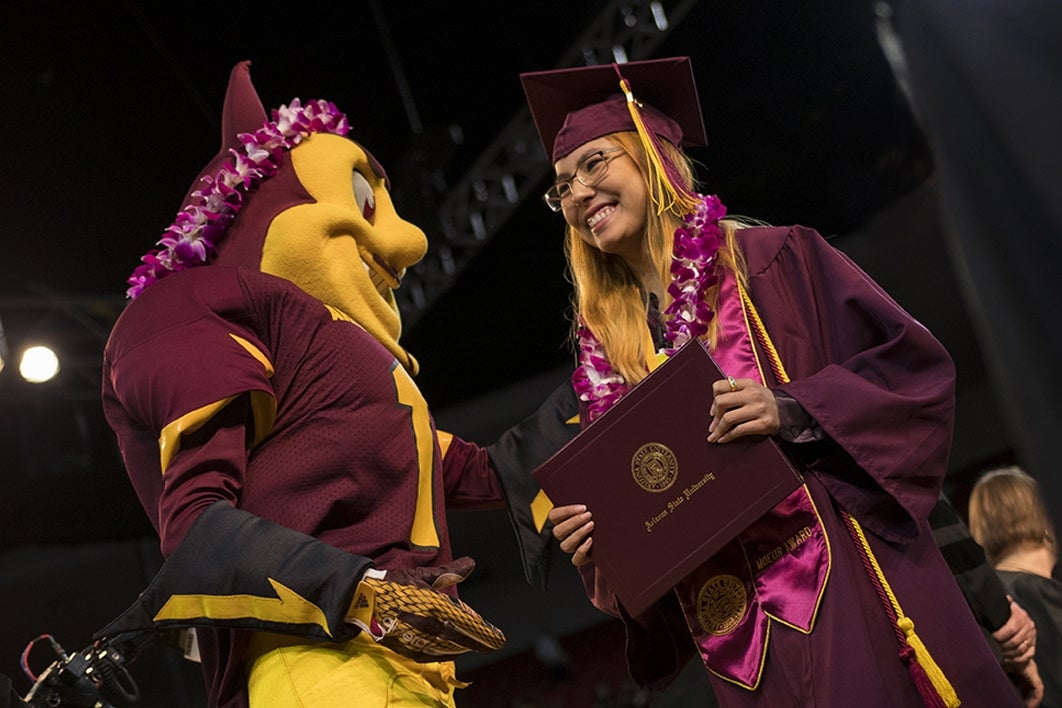 graduate getting a lei from Sparky