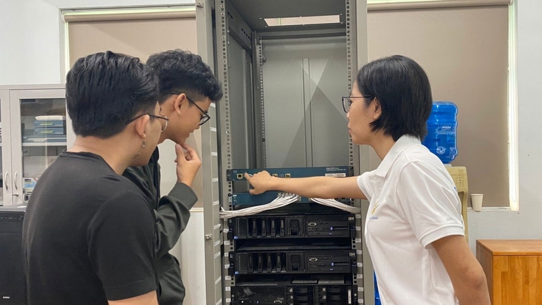 Van Dinh Vy Phuong looks at equipment in a lab at Lac Hong University.