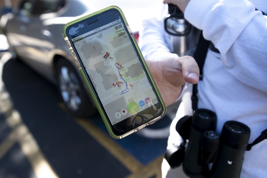 The researchers use a GPS tool to track where the color-banded birds spend their time on campus.