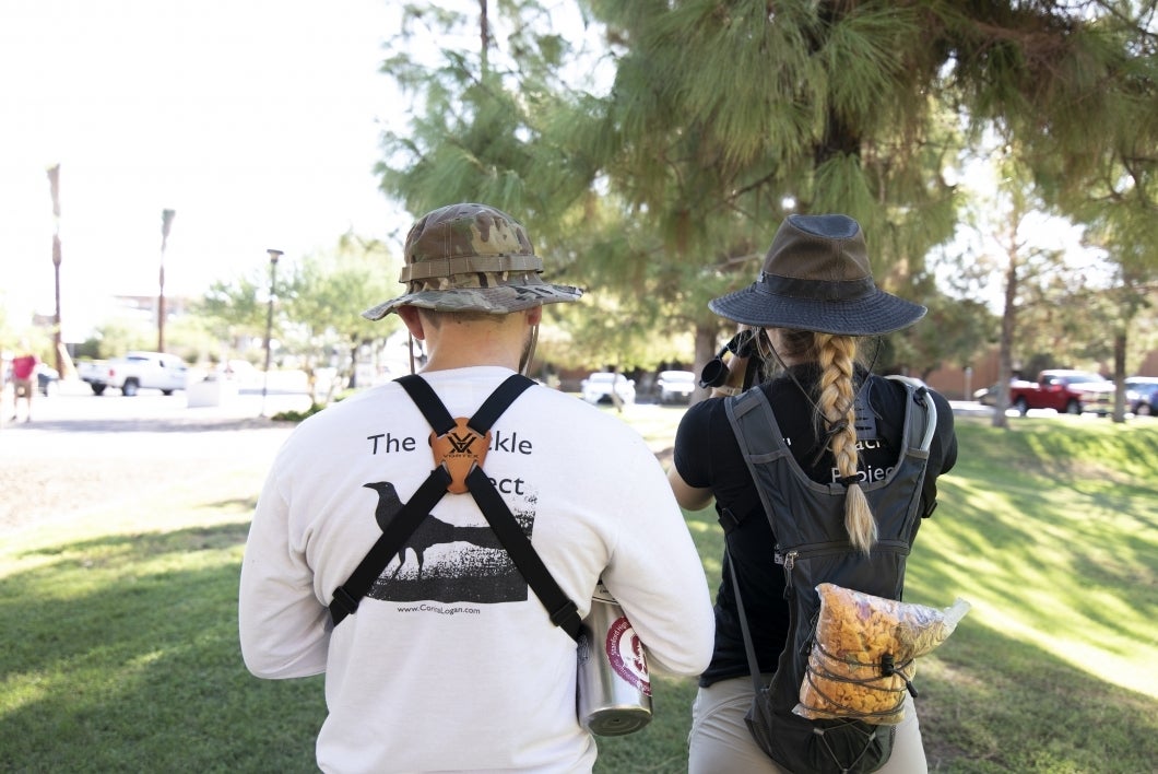 Melissa Folsom and Michael Pickett conduct field work observing grackle behavior on ASU's Tempe campus.