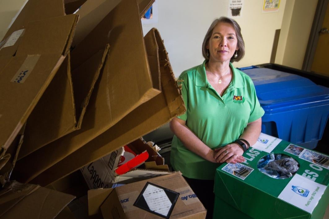 woman with recyclables around her