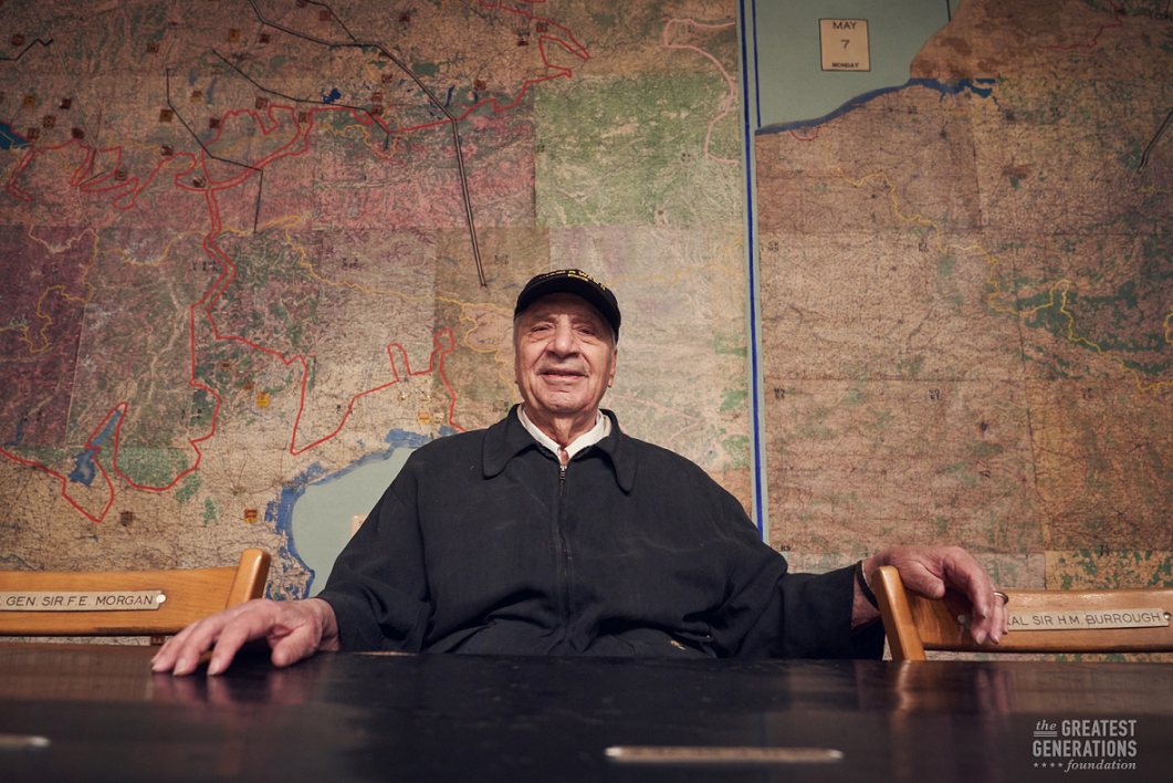 Gregory Melikian sitting at the table where the Germans surrendered in WWII