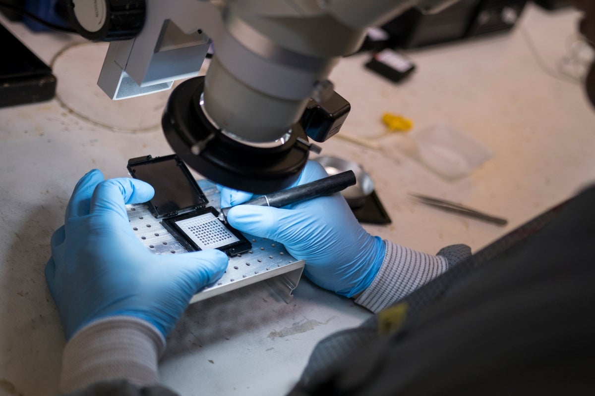 hands assembling nanotech under light