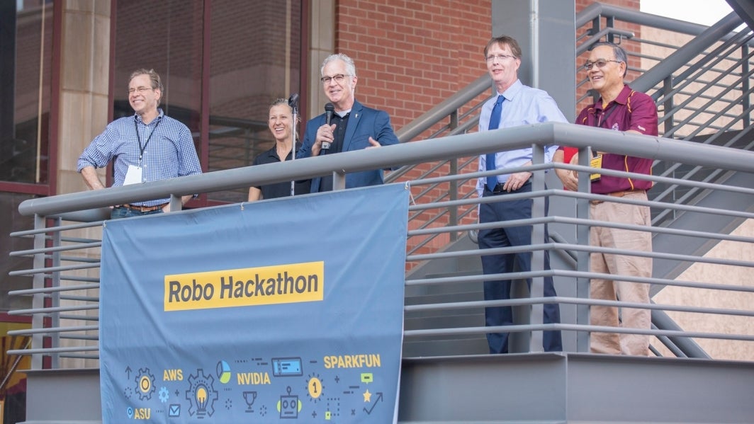 John Rome welcomes participants outside the Brickyard building