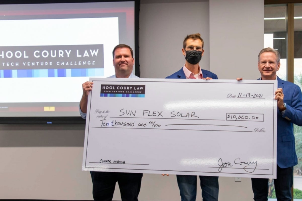 Connor N. Hubach and Michael Hool present a check for $10,000 to Zachary Holman at the ASU Hool Coury Law Tech Venture Showcase.