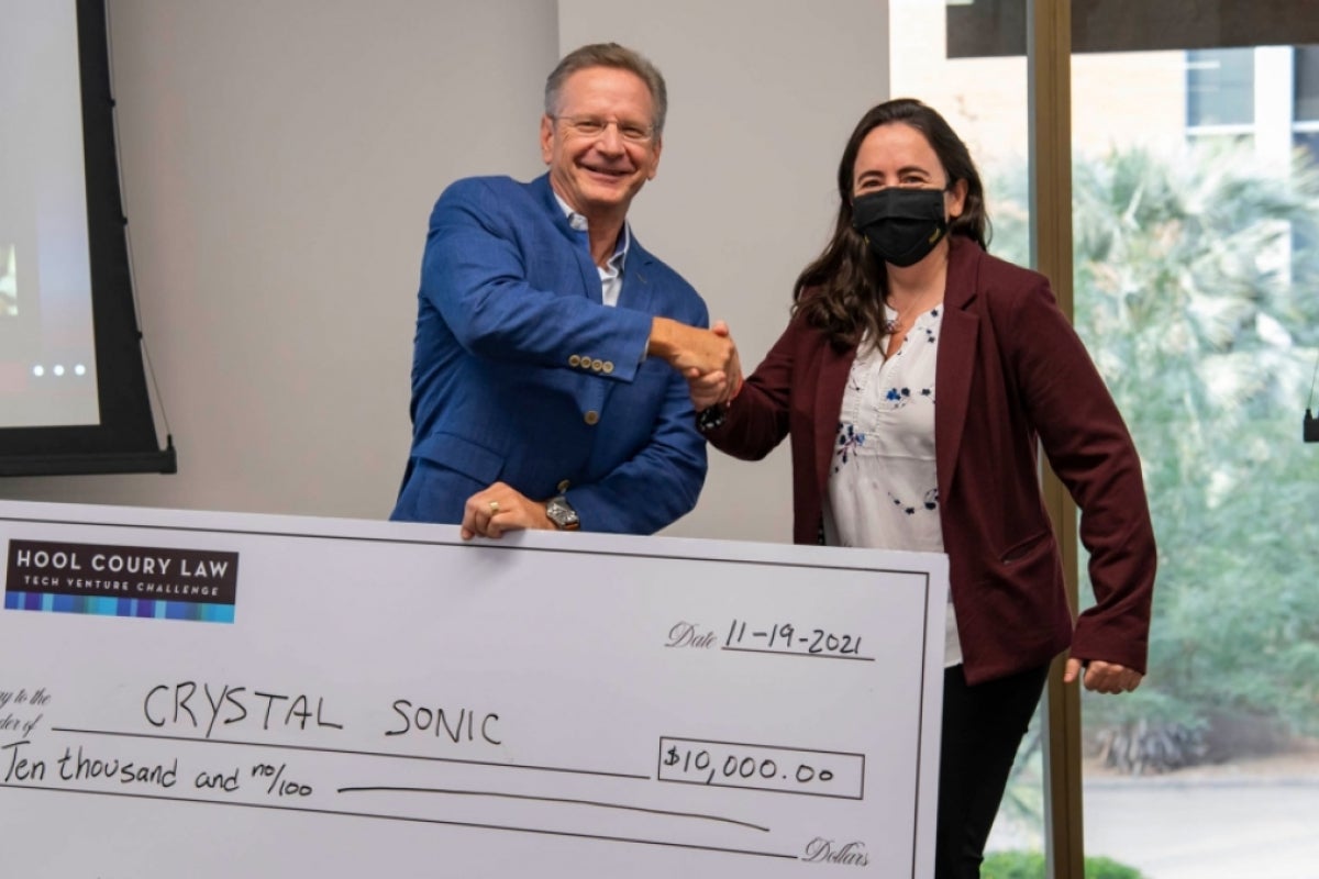 Michael Hool presents a $10,000 check to Mariana Bertoni at the ASU Hool Coury Law Tech Venture Showcase.