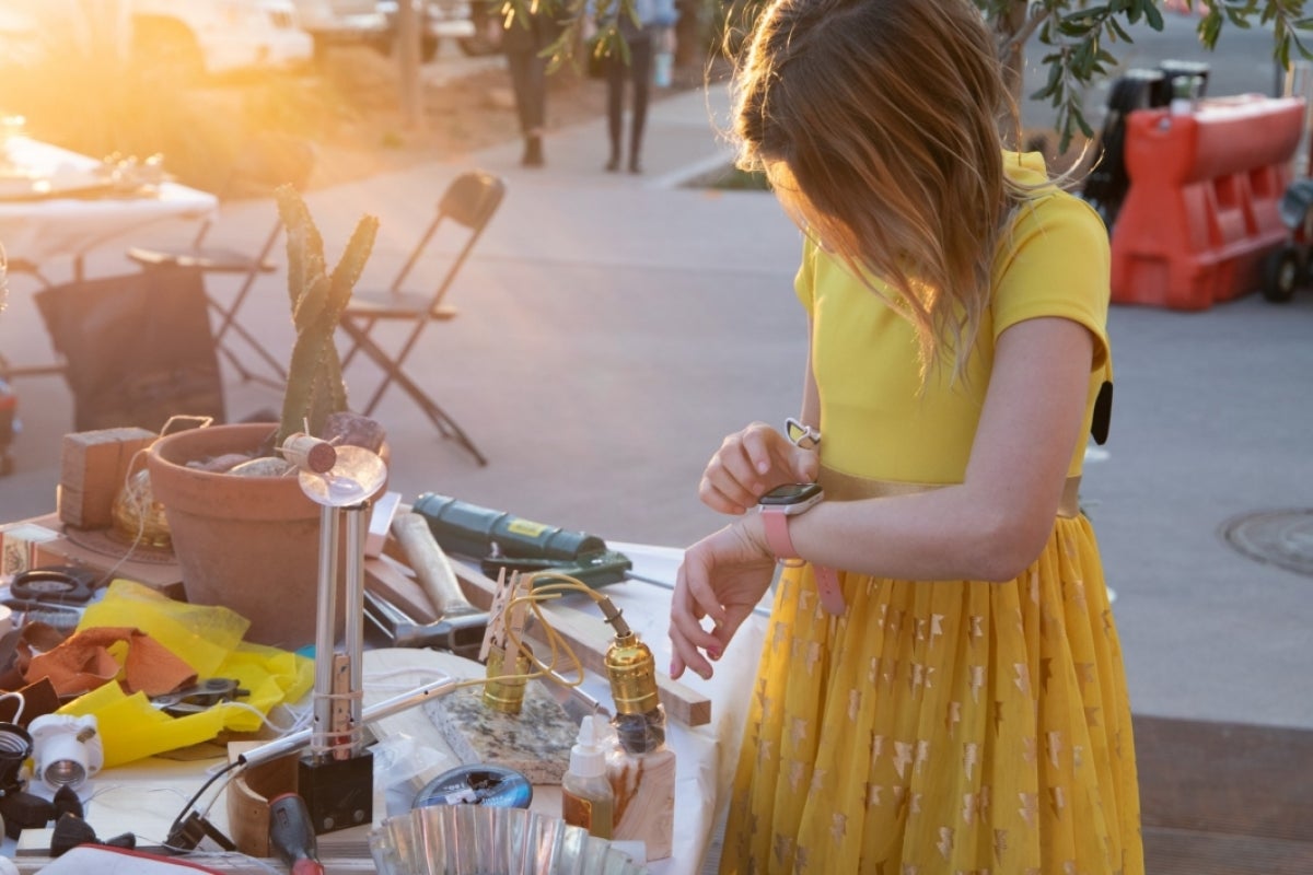 Girl looking at watch at display booth