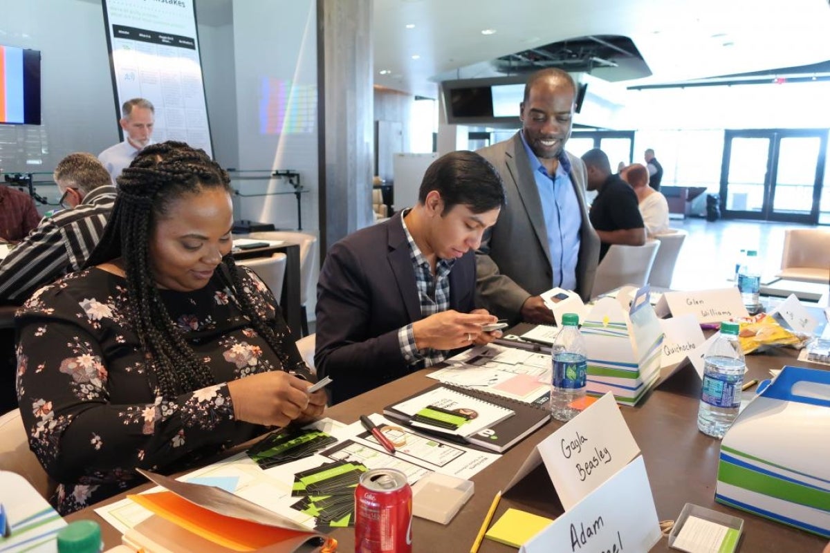 Jon Williams, Deloitte workshop facilitator helps student veterans narrow down task preferences.