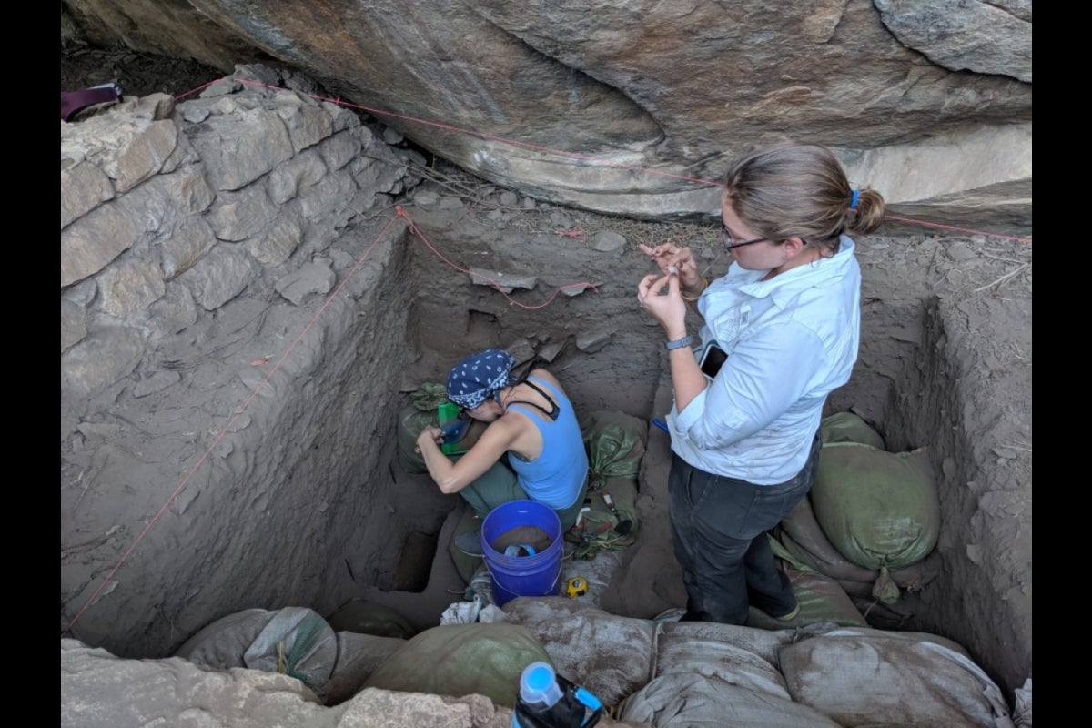 Two people working at an excavation site