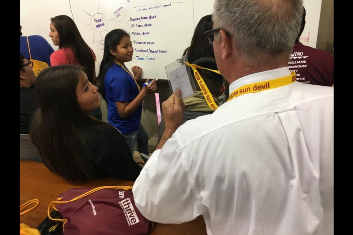 ASU English professor Jim Blasingame checks in with Inspire teams in ASU Changemaker Central