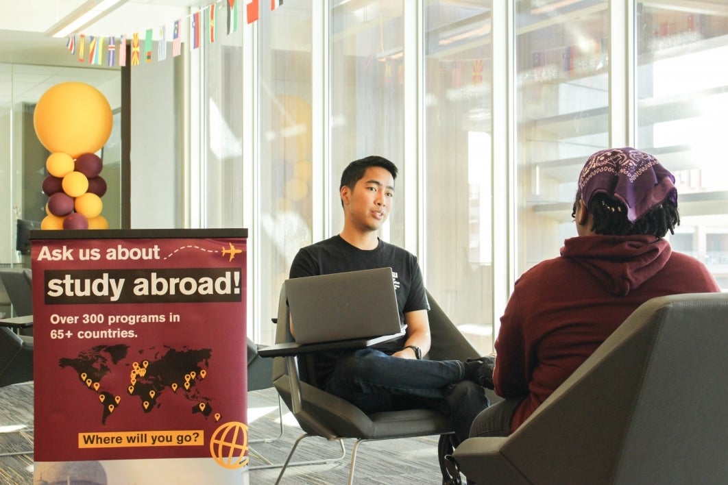 GEO recruiter holds an advising appointment with interested student, sitting in a chair across from them.