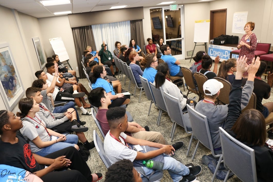 Group of CompuPower students ask questions of presenter during presentation at ASU