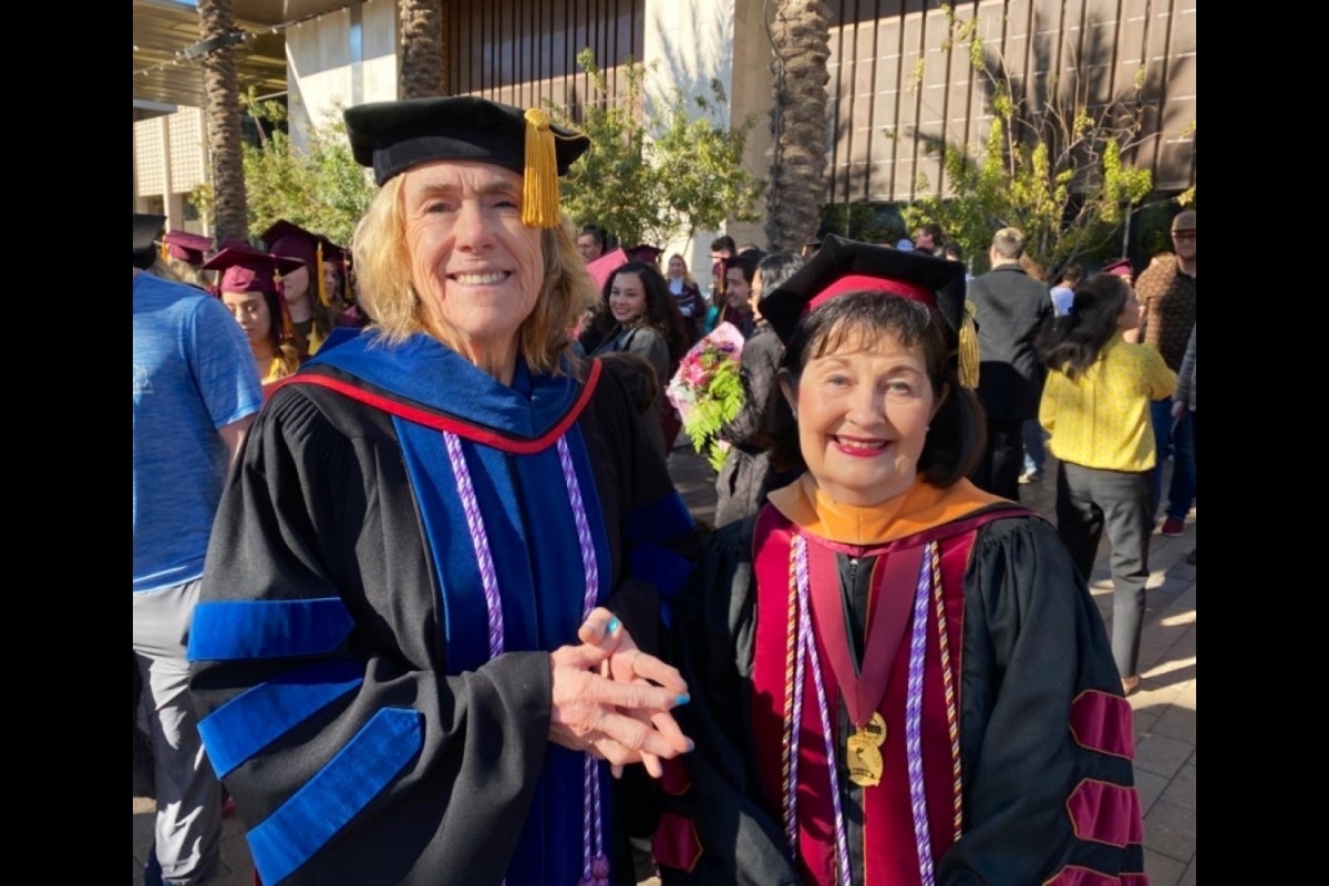 Edson College Dean Judith Karshmer and Associate Dean Katherine Kenny smile in their convocation regalia following one of the Edson College ceremonies