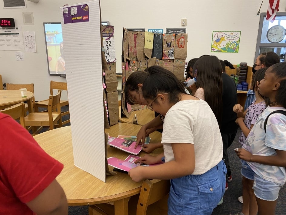 Emerson students reading posters and brochures.