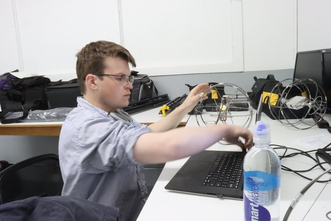 Christopher McCormick works on the ExoCam in the Interplanetary Lab