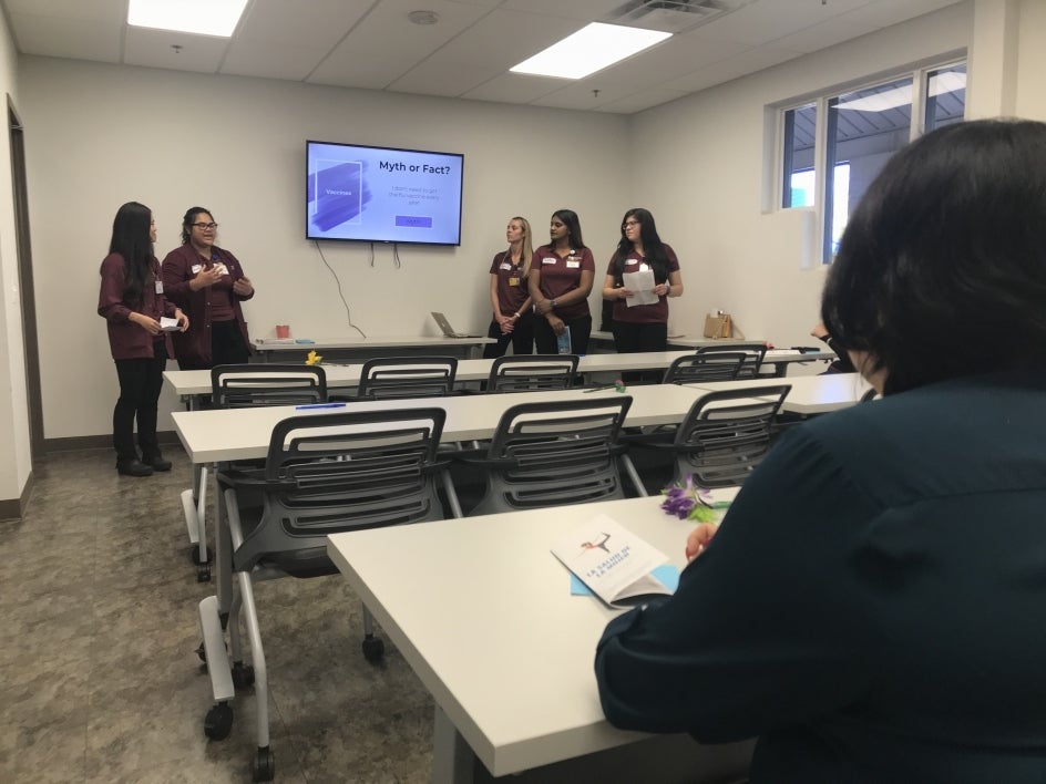 A participant listens as Edson College nursing students present a women's health workshop