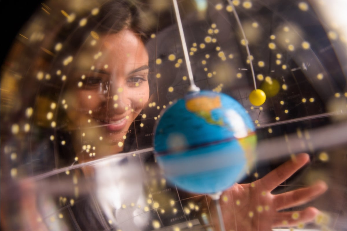 Woman looks through a clear globe