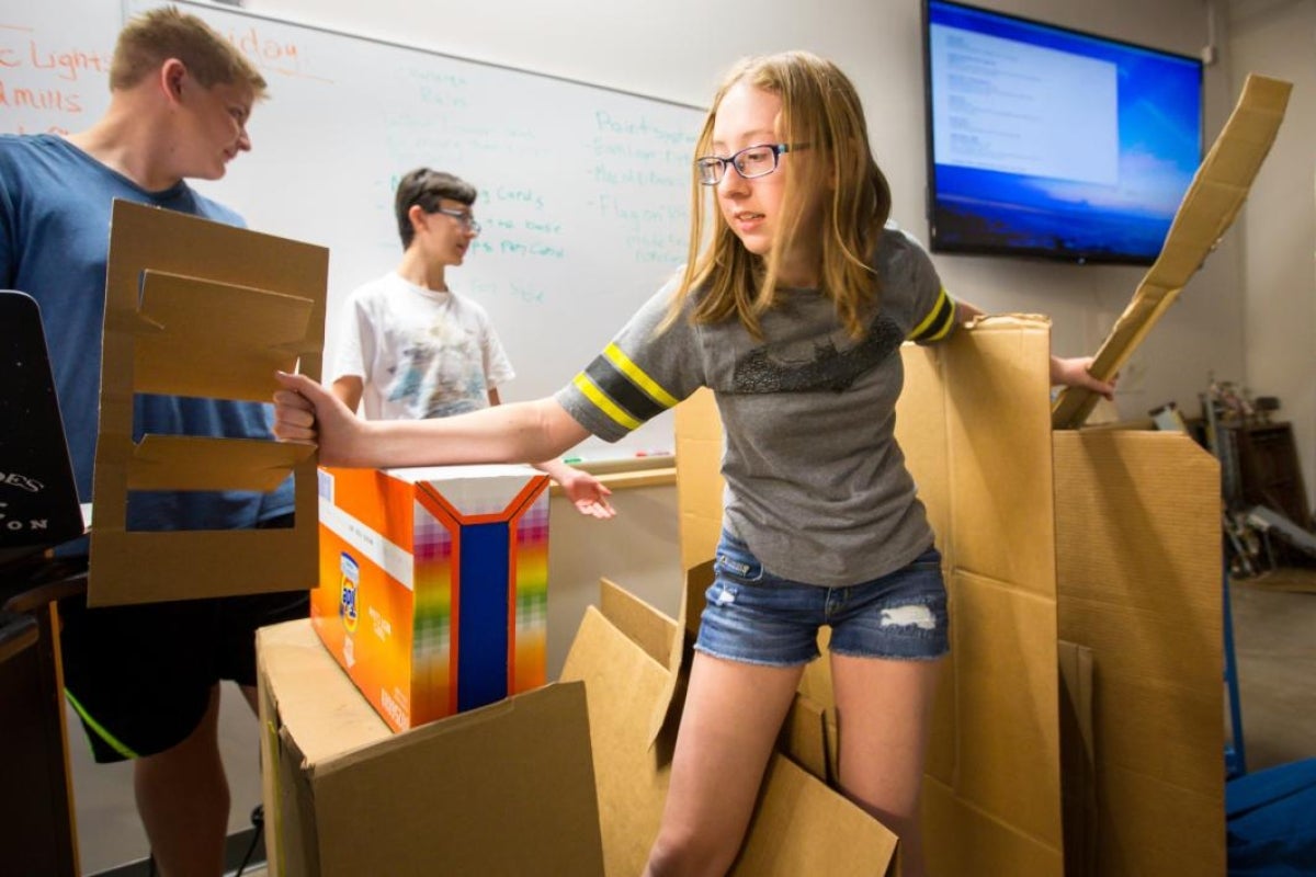 student building cardboard structure